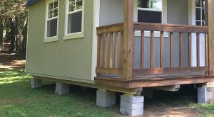 Raised shed supported by concrete block piers, improving airflow and protecting against ground moisture. Block foundations are affordable, adjustable, and best suited for smaller sheds on level ground.