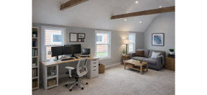 Finished backyard office shed interior with desk and seating, showcasing comfortable workspace alternative to home addition